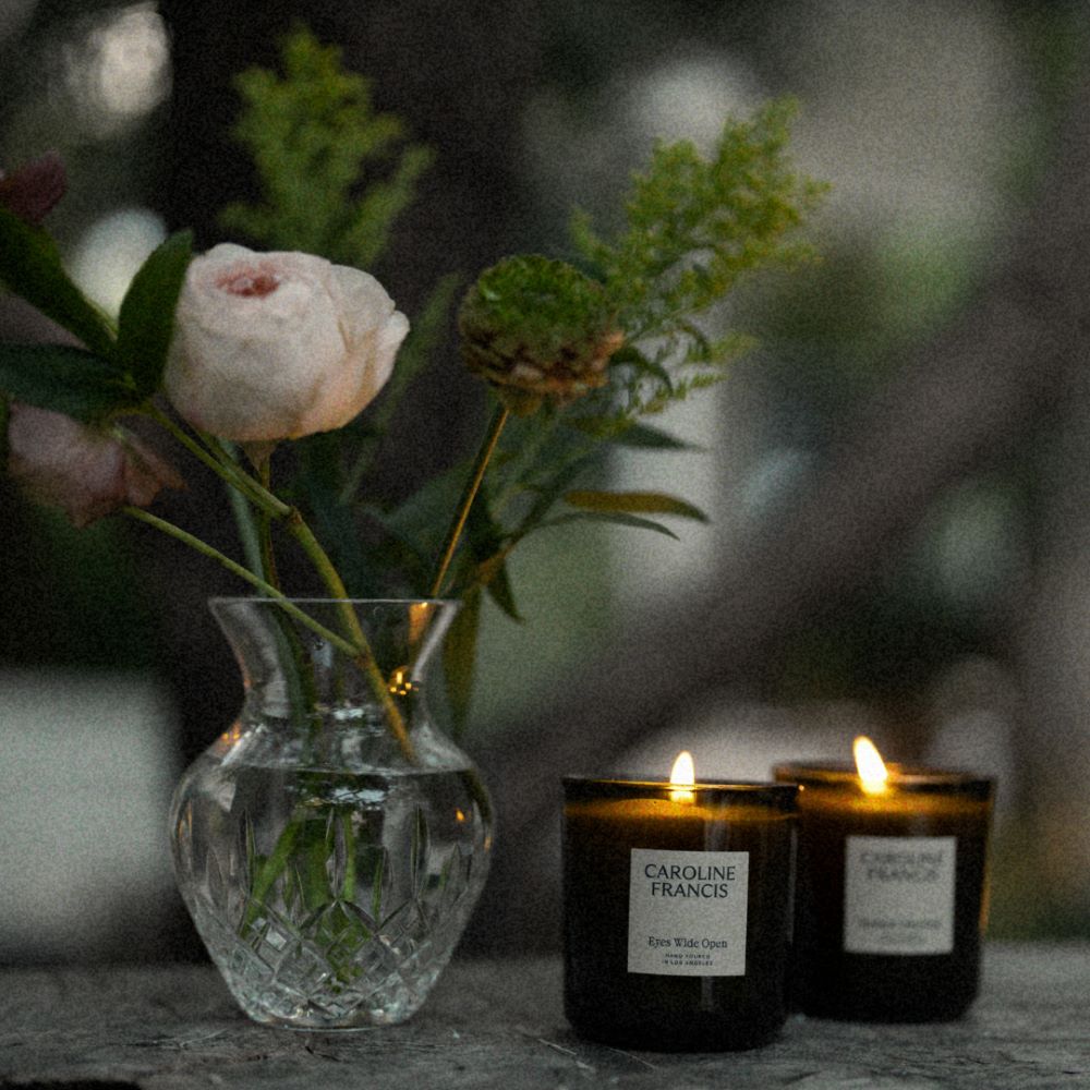 Caroline Francis Candles Burning Beside a Flower Vase