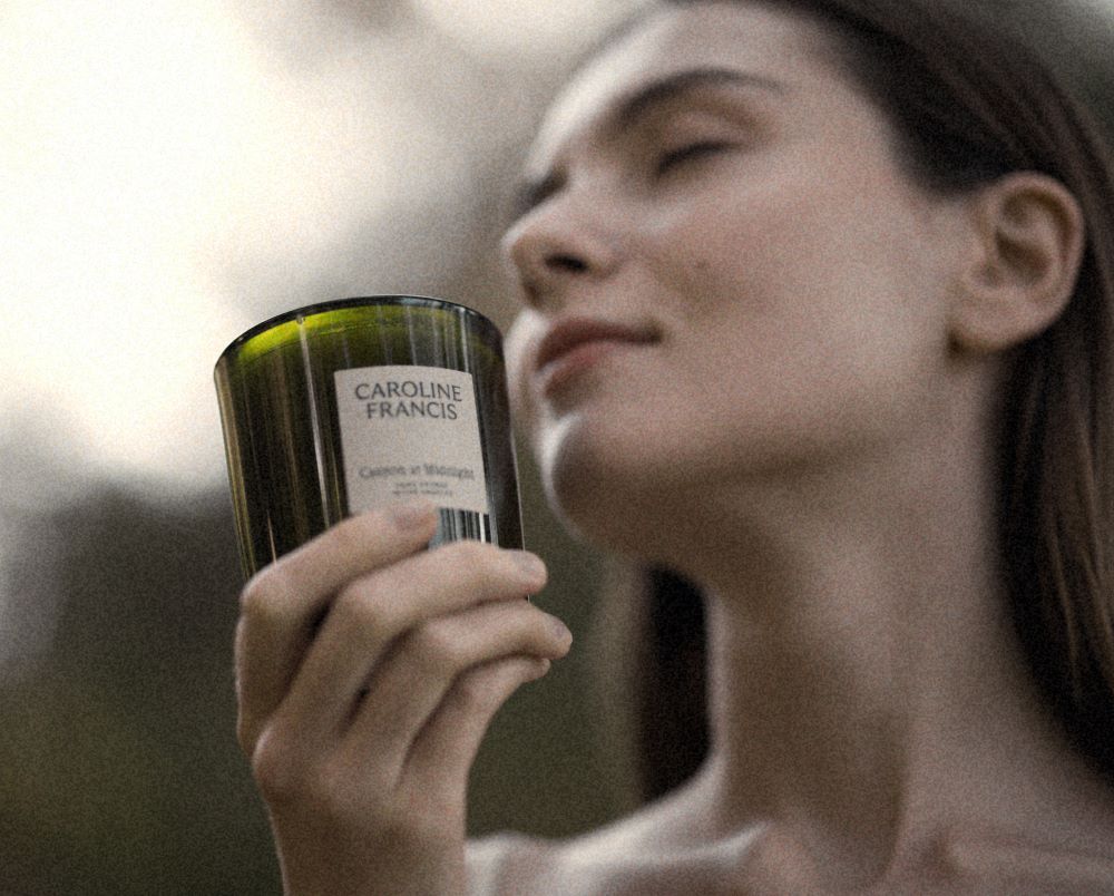 Woman Smelling a Candle